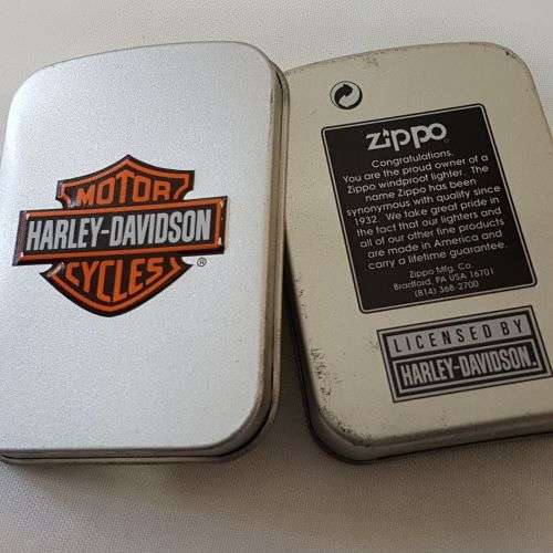 A fantastic polished chrome engraved "Girl with Harley Tattoo" Zippo lighter in box