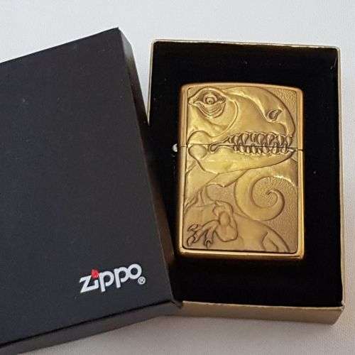 **RS17** A c1993 Zippo Barrett Smythe limited edition "Dinosaurs" T-Rex brass-finished lighter