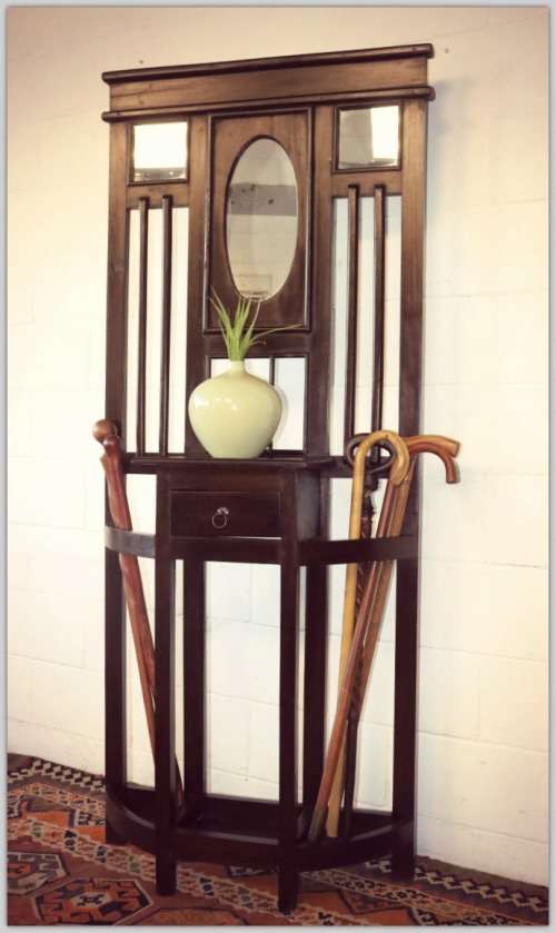 A wonderful tall hall stand with three mirrors, storage drawer and space for umbrellas/ canes