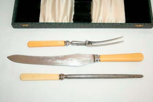 A stunning vintage boxed bone handle style carving knife and fork set with a sharpening steel