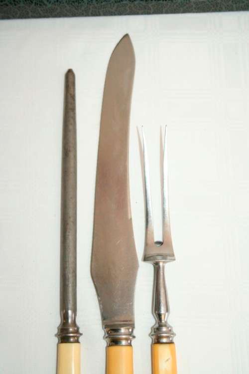 A stunning vintage boxed bone handle style carving knife and fork set with a sharpening steel