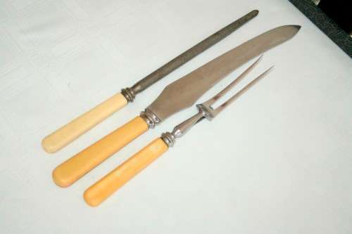 A stunning vintage boxed bone handle style carving knife and fork set with a sharpening steel
