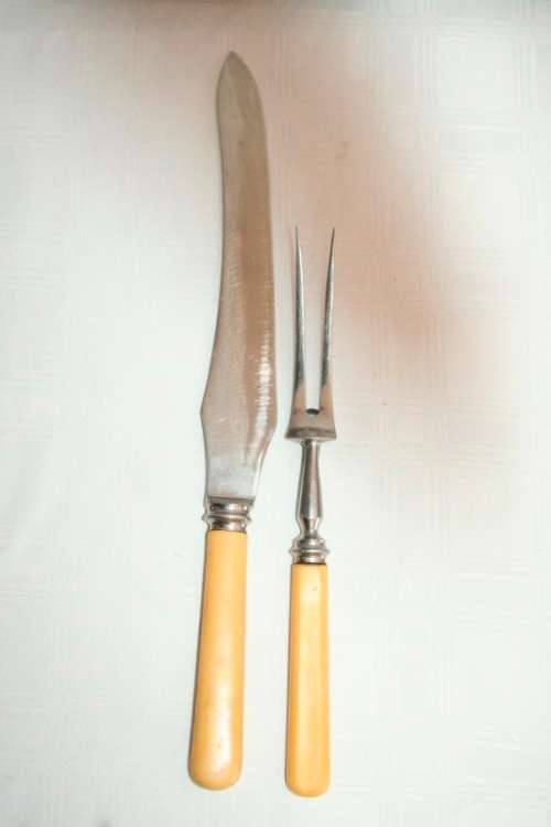 A stunning vintage boxed bone handle style carving knife and fork set with a sharpening steel