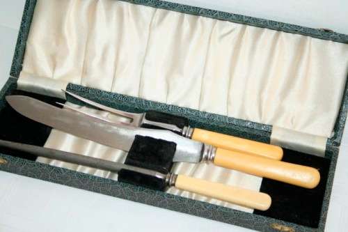 A stunning vintage boxed bone handle style carving knife and fork set with a sharpening steel