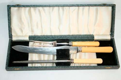 A stunning vintage boxed bone handle style carving knife and fork set with a sharpening steel