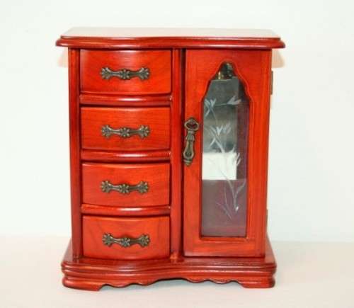 A wonderful wooden upright jewellery box with four drawers, ring slots & a rotating necklace holder