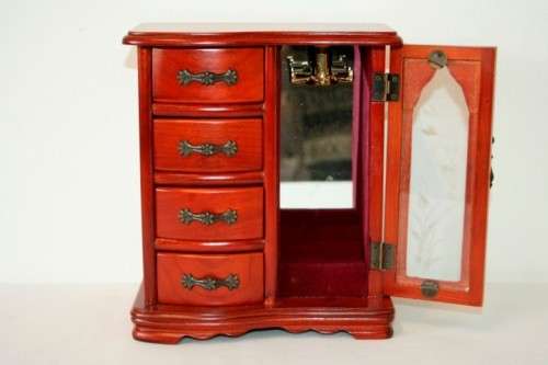 A wonderful wooden upright jewellery box with four drawers, ring slots & a rotating necklace holder