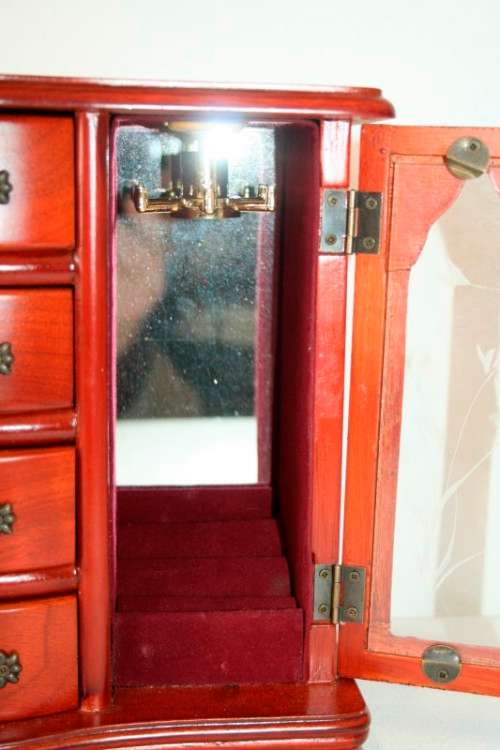 A wonderful wooden upright jewellery box with four drawers, ring slots & a rotating necklace holder