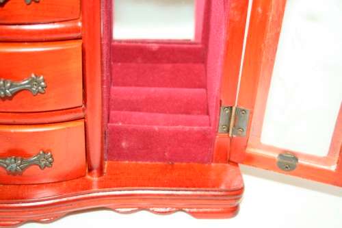 A wonderful wooden upright jewellery box with four drawers, ring slots & a rotating necklace holder