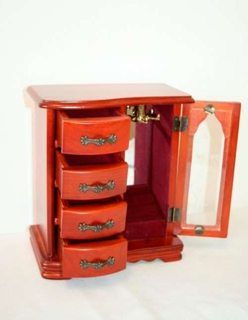 A wonderful wooden upright jewellery box with four drawers, ring slots & a rotating necklace holder