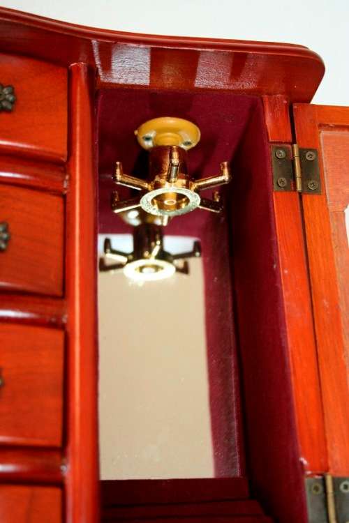 A wonderful wooden upright jewellery box with four drawers, ring slots & a rotating necklace holder