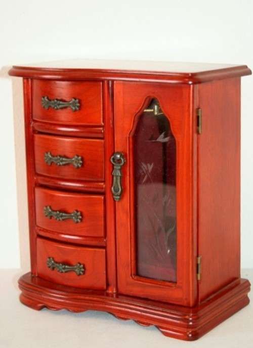 A wonderful wooden upright jewellery box with four drawers, ring slots & a rotating necklace holder