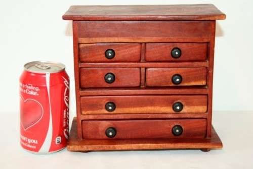 An awesome hand made solid teak jewellery box with six drawers and a storage tray under the lid