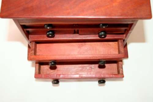 An awesome hand made solid teak jewellery box with six drawers and a storage tray under the lid