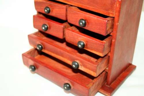 An awesome hand made solid teak jewellery box with six drawers and a storage tray under the lid