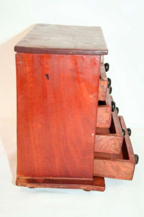 An awesome hand made solid teak jewellery box with six drawers and a storage tray under the lid