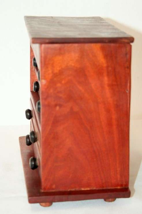 An awesome hand made solid teak jewellery box with six drawers and a storage tray under the lid