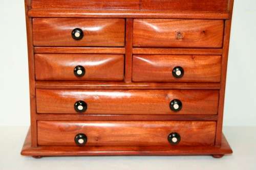A gorgeous hand made solid teak jewellery box with six drawers and a storage section on top