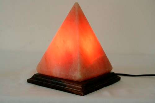 An incredible "Pyramid" Himalayan Crystal Salt lamp on a wooden base in complete working condition