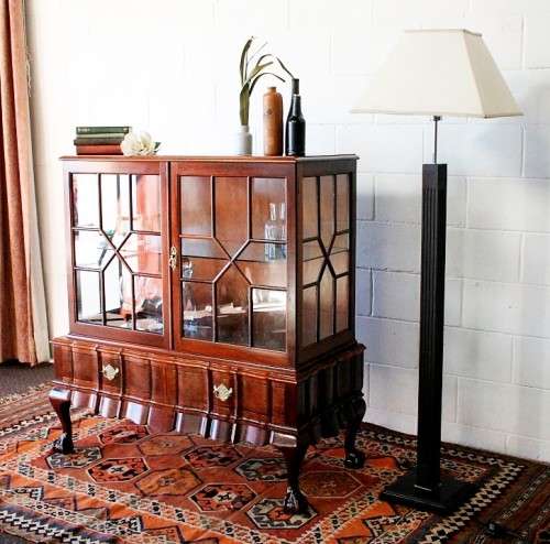 A beautiful vintage Imbuia ball and claw double door show-cabinet with two drawers & glass shelf.
