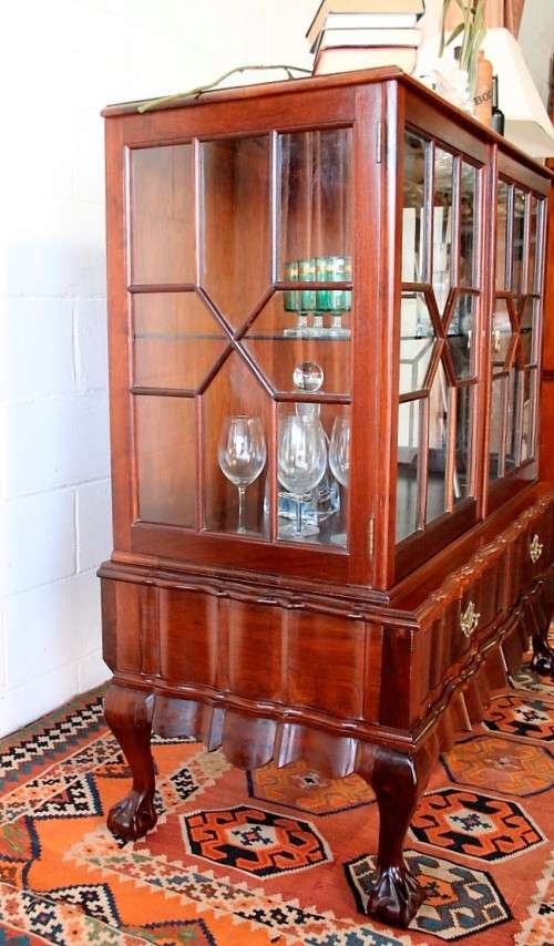 A beautiful vintage Imbuia ball and claw double door show-cabinet with two drawers & glass shelf.
