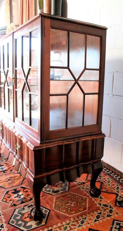 A beautiful vintage Imbuia ball and claw double door show-cabinet with two drawers & glass shelf.