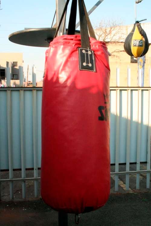 A well made steel boxing stand with a "SNT" punching bag and an "Everlast" speed bag = for home use!