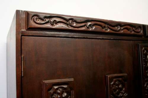 A stunning Imbuia-finished double door wardrobe with hand carved rosettes and facade detailing