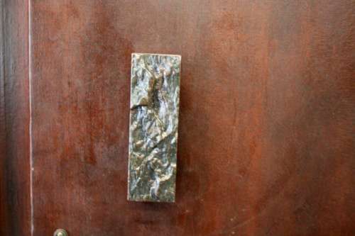 A stunning Imbuia-finished double door wardrobe with hand carved rosettes and facade detailing