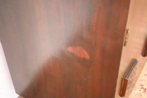 A stunning Imbuia-finished double door wardrobe with hand carved rosettes and facade detailing