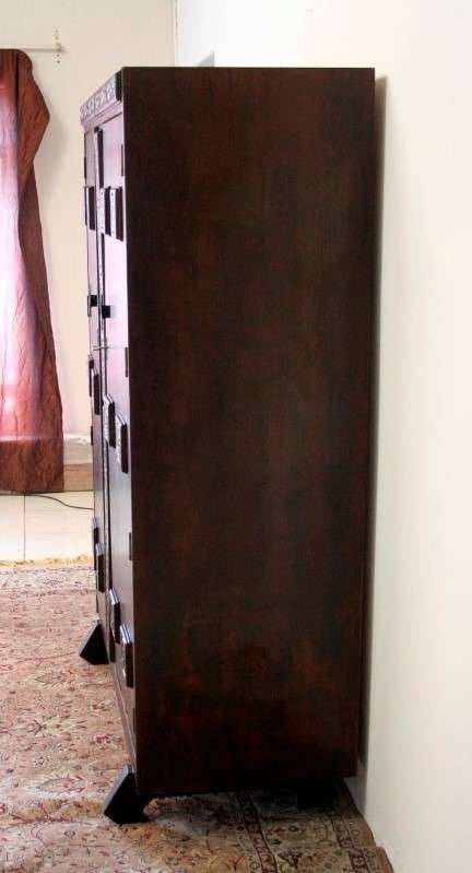 A stunning Imbuia-finished double door wardrobe with hand carved rosettes and facade detailing