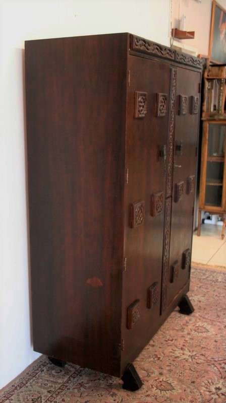 A stunning Imbuia-finished double door wardrobe with hand carved rosettes and facade detailing