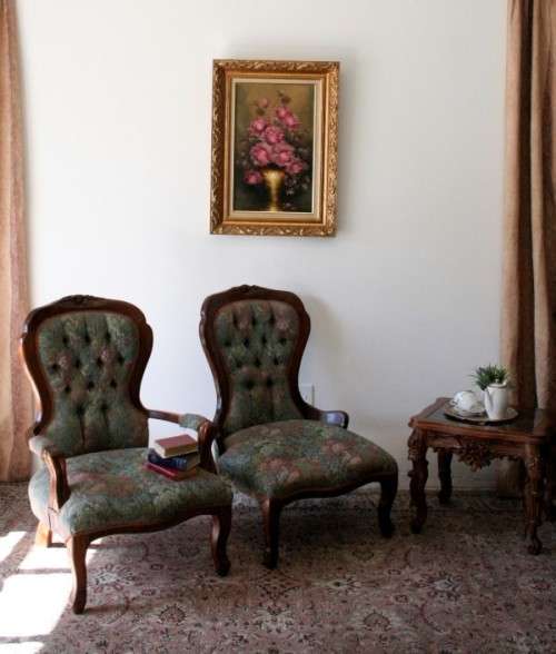 Wow! Magnificent pair of Victorian "king and queen" hand carved chairs with deep button detailing!