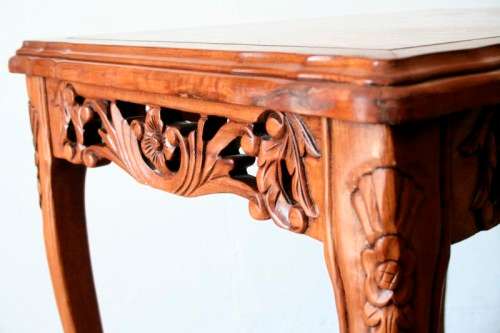 A wonderful and stylish teak side table with a marble top and beautifully carved detailing