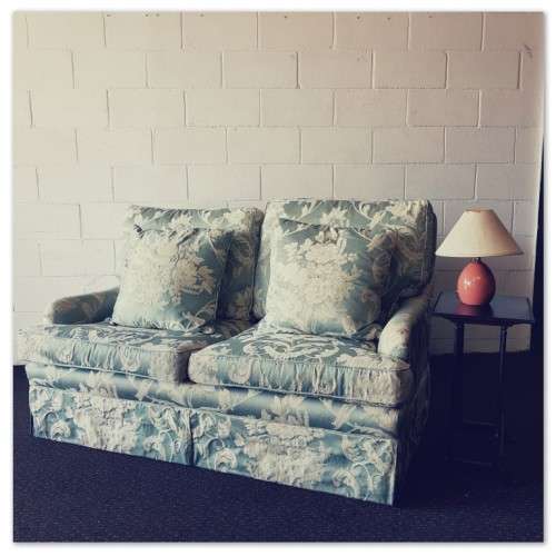 A wonderful "Moorgas & Sons" Brocade fabric couch with cushions & a floral pattern on it