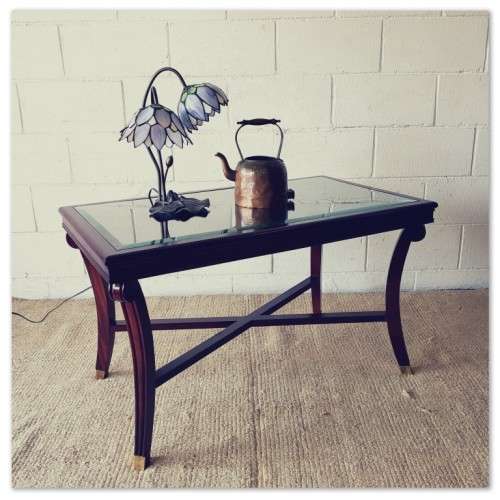 A stylish vintage Mahogany glass-top coffee/ occasional table with Brass feet caps in good condition
