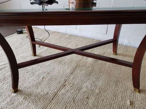 A stylish vintage Mahogany glass-top coffee/ occasional table with Brass feet caps in good condition