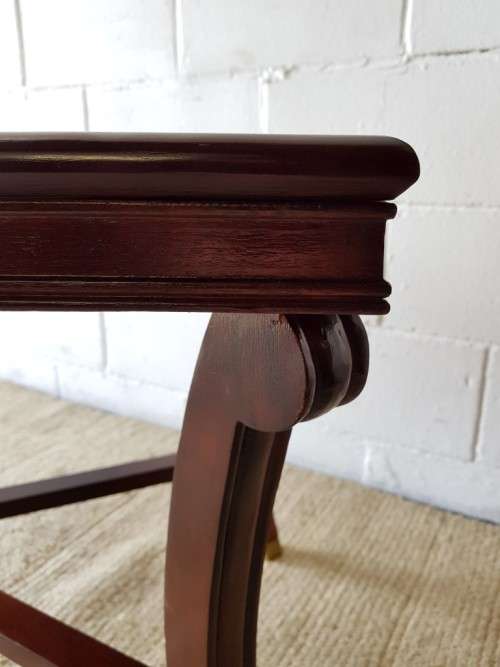 A stylish vintage Mahogany glass-top coffee/ occasional table with Brass feet caps in good condition