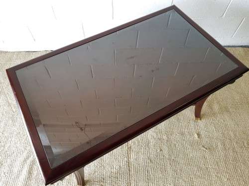 A stylish vintage Mahogany glass-top coffee/ occasional table with Brass feet caps in good condition