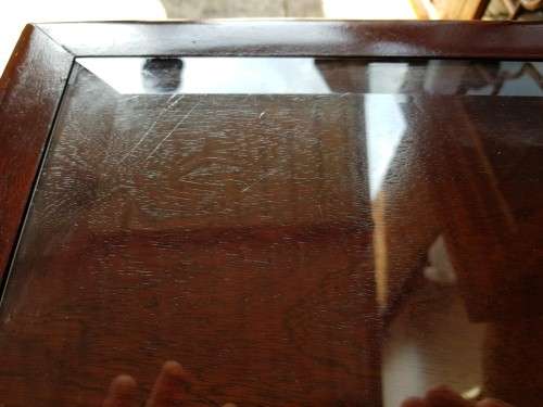 A stylish vintage Mahogany glass-top coffee/ occasional table with Brass feet caps in good condition