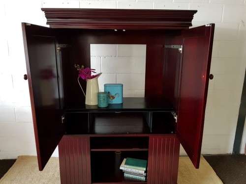 A gorgeous mahogany TV-Cabinet with two doors and ample space for an entertainment system