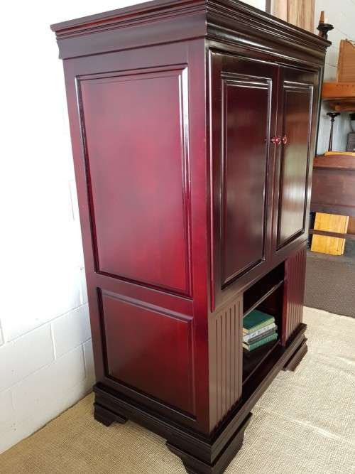 A gorgeous mahogany TV-Cabinet with two doors and ample space for an entertainment system