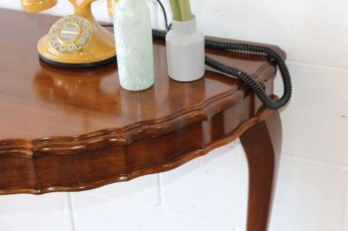 An amazing vintage (larger than normal) Stinkwood ball & claw half moon display/occasional table