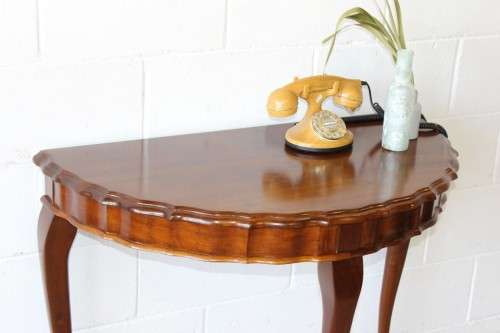 An amazing vintage (larger than normal) Stinkwood ball & claw half moon display/occasional table