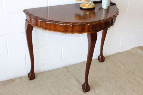An amazing vintage (larger than normal) Stinkwood ball & claw half moon display/occasional table