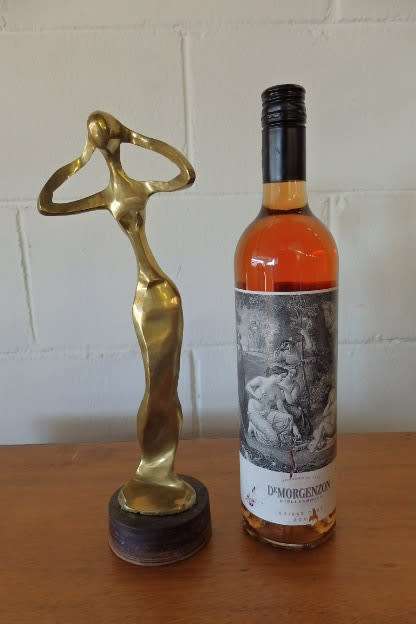 A beautiful tall ornamental brass abstract figurine on a wooden stand in wonderful condition