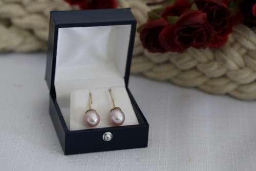 A stunning pair of pink Japanese Akoya pearl earrings with 9ct gold hooks in its original gift box