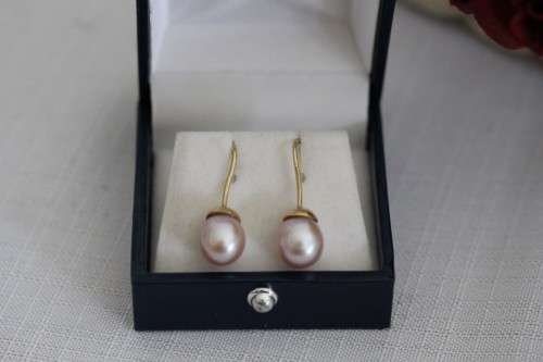A stunning pair of pink Japanese Akoya pearl earrings with 9ct gold hooks in its original gift box