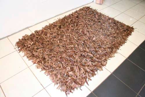 **RS17** A striking and unusual shaggy-leather carpet in shades of brown colours