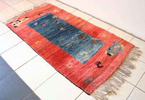 A fabulous thick pile colourful carpet in shades of red and blue colours.